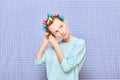 Portrait of serious girl with bright colorful hair curlers on head Royalty Free Stock Photo