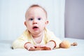 Portrait of a cute seven-month-old girl with blue eyes. A child plays with wooden toys in a bright room. Eco-friendly toys for Royalty Free Stock Photo