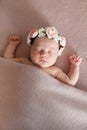 Portrait of cute sleeping newborn baby girl wearing flower headband. Royalty Free Stock Photo