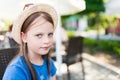 Portrait of a cute but slightly irritated little girl wearing a hat Royalty Free Stock Photo