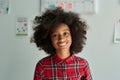 Portrait of cute smiling afro American schoolgirl standing in classroom. Royalty Free Stock Photo