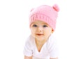 Portrait cute smiling baby in knitted pink hat on white