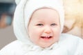 Portrait of a cute smiling Caucasian baby girl outside. Child toddler in white warm clothes walking outdoor. Laughing funny lovely Royalty Free Stock Photo