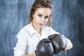 Female Boxer Posing in Brown Leather Boxer Gloves Against Blackboard Royalty Free Stock Photo