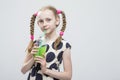 Portrait Of Cute And smiling Caucasian Little Girl With Pigtails Posing in Polka Dot Dress