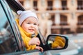 Portrait of a cute smiling child looking out of a car window. Family vacation Royalty Free Stock Photo