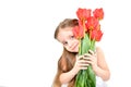 Portrait of a cute smiling girl holding a bouquet of tulips in her hands Royalty Free Stock Photo