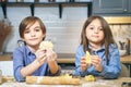 Portrait of cute smiling kids boy and girl making cookies from dough in the kitchen Royalty Free Stock Photo