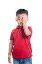 Portrait of cute smiling little boy closed one eye with his hand Royalty Free Stock Photo