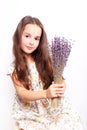 Portrait of cute smiling little girl with bunch of lavender flowers