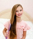 Portrait of cute smiling little girl child brushing her hair Royalty Free Stock Photo