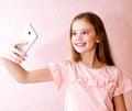 Portrait of cute little girl taking a selfie isolated Royalty Free Stock Photo