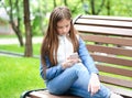 Portrait of cute smiling  little girl child using phone smartphone Royalty Free Stock Photo