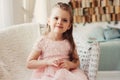 Portrait of cute smiling 5 years old child girl sitting on chair Royalty Free Stock Photo