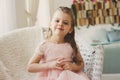 Portrait of cute smiling 5 years old child girl sitting on chair Royalty Free Stock Photo