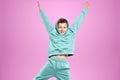 Portrait, cute stylish boy in a blue suit on a pink background. Studio portrait of a child, modern design, trendy background,