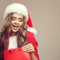 Portrait of cute surprised woman in santa hat. Royalty Free Stock Photo