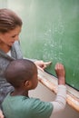 Portrait of a cute teacher and a pupil making an addition Royalty Free Stock Photo
