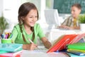 Portrait of cute teen girl doing homework in her room Royalty Free Stock Photo