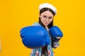 Portrait of a cute teenage boxer girl on yellow isolated background. Funny winner child girl. Success, leader concept.