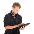 Portrait of a cute teenage boy with headphones and tablet computer. Royalty Free Stock Photo