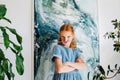 Portrait of playful teenage redhead girl with brush as mustache Royalty Free Stock Photo