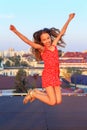 Portrait of a cute teenager girl  smiling and jumping outdoors at summer evening Royalty Free Stock Photo