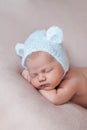 Portrait of cute ten days old newborn baby girl wearing bear bonnet with ears. Royalty Free Stock Photo