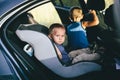 Portrait of cute toddler boy sitting in car seat. Child transportation safety Royalty Free Stock Photo