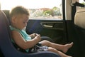 Portrait of cute toddler boy sitting in car seat. Child transportation safety Royalty Free Stock Photo