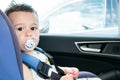 Portrait of cute toddler boy sitting in car seat. Child transportation safety Royalty Free Stock Photo