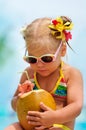 Portrait of cute toddler girl with coconut