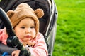 Portrait of a cute toddler girl in a stroller in the park Royalty Free Stock Photo