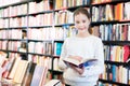 tweenager girl reading interesting book in bookstore Royalty Free Stock Photo