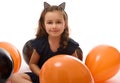 Portrait of cute 4 years old witch girl in Halloween costume with colorful black and orange balloons isolated on white background Royalty Free Stock Photo