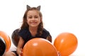 Portrait of cute witch girl in Halloween dress and hoop with cat ears having fun with colorful black and orange balloons isolated Royalty Free Stock Photo