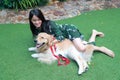 Portrait of cute woman playing with dog on green grass Royalty Free Stock Photo