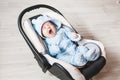 Portrait of cute yawning mixed race baby boy sitting in car seat. Child transportation safety Royalty Free Stock Photo