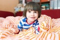 Portrait of cute 2 years child in bed at home