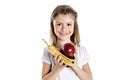 Portrait of a cute 7 years old girl Isolated over white background with apple, banana and avocado Royalty Free Stock Photo