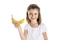 Portrait of a cute 7 years old girl Isolated over white background with banana Royalty Free Stock Photo