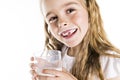 Portrait of a cute 7 years old girl Isolated over white background with milk glass Royalty Free Stock Photo