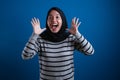 Portrait of cute young Asian muslim college student girl wearing hijab shows surprised or shocked expression Royalty Free Stock Photo