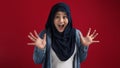 Portrait of cute young Asian muslim lady wearing hijab shows surprised or shocked expression with big eyes and open mouth Royalty Free Stock Photo