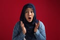 Portrait of cute young Asian muslim lady wearing hijab shows surprised or shocked expression with big eyes and open mouth Royalty Free Stock Photo
