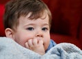 portrait of a cute young boy and his safety blanket