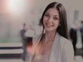 Portrait of a cute young business woman smiling, in an office environment Royalty Free Stock Photo