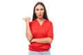 portrait of a cute young european brunette lady in a red t-shirt actively gesturing with her index finger towards the Royalty Free Stock Photo