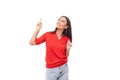 portrait of a cute young european brunette lady in a red t-shirt actively gesturing with her index finger towards the Royalty Free Stock Photo