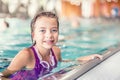 Portrait of a cute young girl with goggles in swimming pool. Swimming training Royalty Free Stock Photo